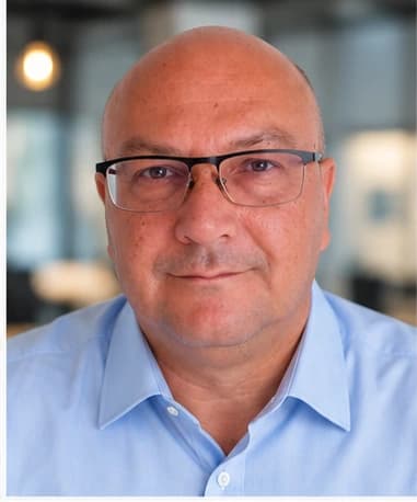 Gerry Walter, wearing glasses and a light blue business shirt